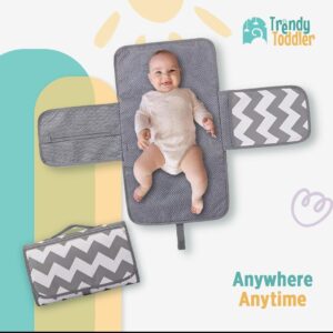 Trendy Toddler Portable Baby Changing Pad – Compact, Comfortable & Convenient Make diaper changes stress-free with the Trendy Toddler Portable Baby Changing Pad! Designed with modern parents in mind, this foldable and stylish changing pad ensures your baby stays clean and comfy anytime, anywhere. Key Features: All-in-One Design: Includes a padded changing surface with extended side flaps, providing a clean and secure space for your baby. Waterproof & Easy to Clean: The interior is made with a water-resistant material that can be wiped clean in seconds. Portable & Lightweight: Folds neatly into a compact clutch with a secure handle, perfect for tossing into your diaper bag or carrying on its own. Storage Pockets: Equipped with mesh and zipper compartments to hold diapers, wipes, creams, and other baby essentials. Trendy Design: Features a modern gray chevron pattern that’s both gender-neutral and stylish. Perfect For: Busy parents on the go Travel, errands, park trips, or visits to friends and family Keeping in the car or stroller for emergencies Slogan: Anywhere. Anytime.