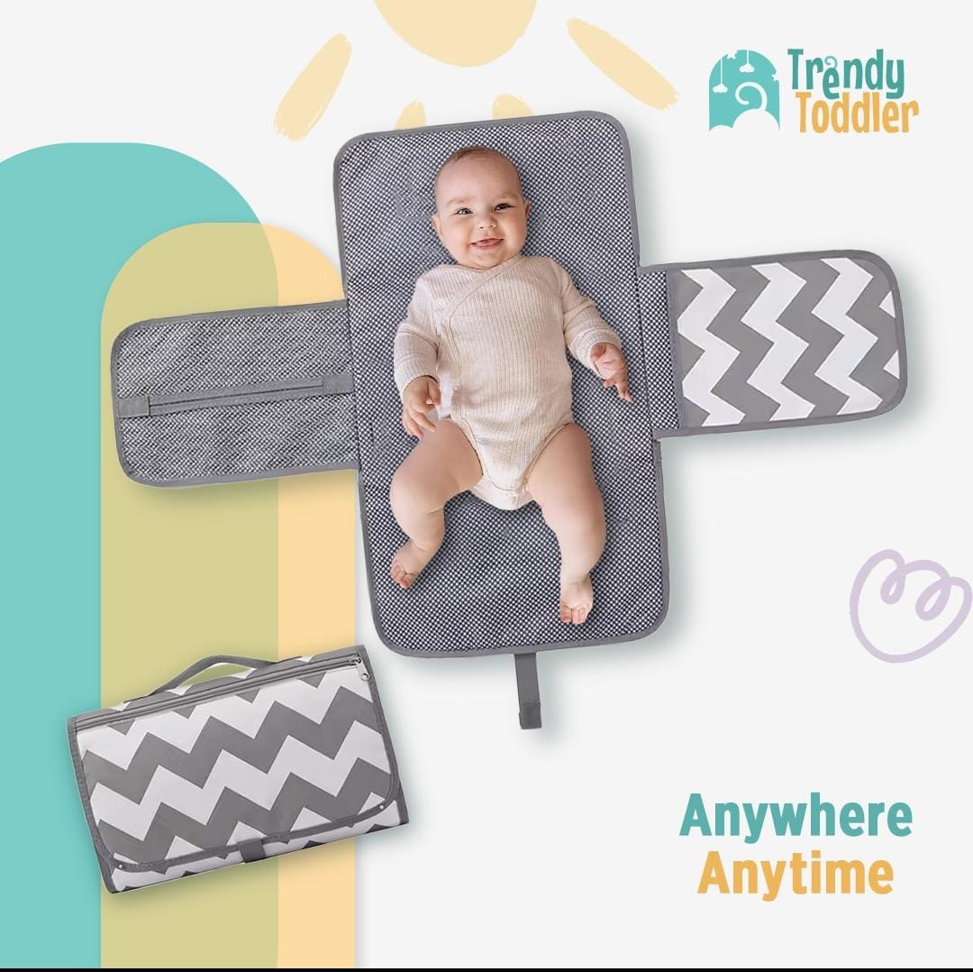 Trendy Toddler Portable Baby Changing Pad – Compact, Comfortable & Convenient Make diaper changes stress-free with the Trendy Toddler Portable Baby Changing Pad! Designed with modern parents in mind, this foldable and stylish changing pad ensures your baby stays clean and comfy anytime, anywhere. Key Features: All-in-One Design: Includes a padded changing surface with extended side flaps, providing a clean and secure space for your baby. Waterproof & Easy to Clean: The interior is made with a water-resistant material that can be wiped clean in seconds. Portable & Lightweight: Folds neatly into a compact clutch with a secure handle, perfect for tossing into your diaper bag or carrying on its own. Storage Pockets: Equipped with mesh and zipper compartments to hold diapers, wipes, creams, and other baby essentials. Trendy Design: Features a modern gray chevron pattern that’s both gender-neutral and stylish. Perfect For: Busy parents on the go Travel, errands, park trips, or visits to friends and family Keeping in the car or stroller for emergencies Slogan: Anywhere. Anytime.